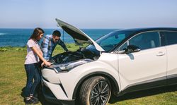 Young couple tries to fix the broken down car