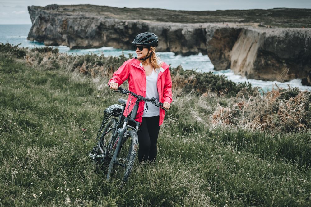 Female bicyclist on rocks