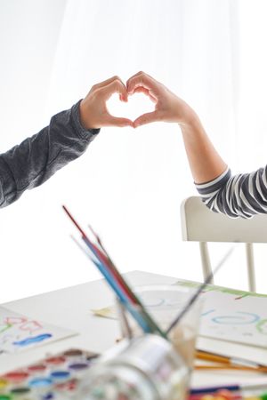 Unrecognizable kids making heart gesture