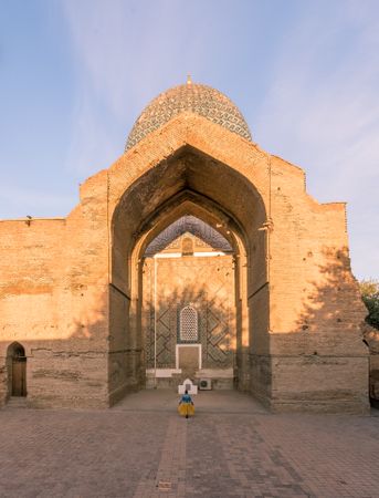 Female tourist in entrance of ornamental building