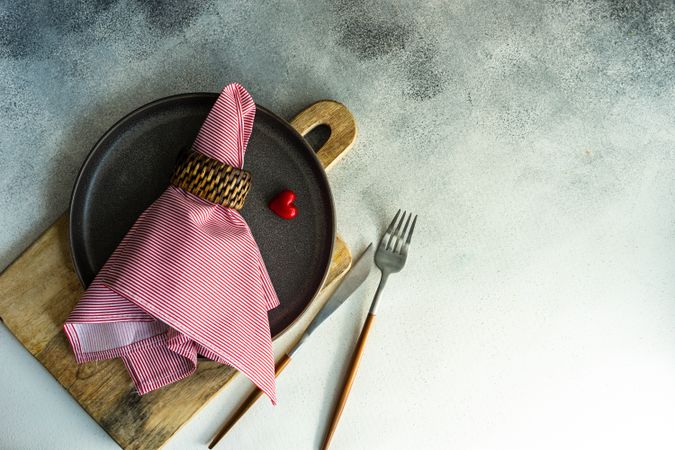 St. Valentine day card concept with red napkin and bread board