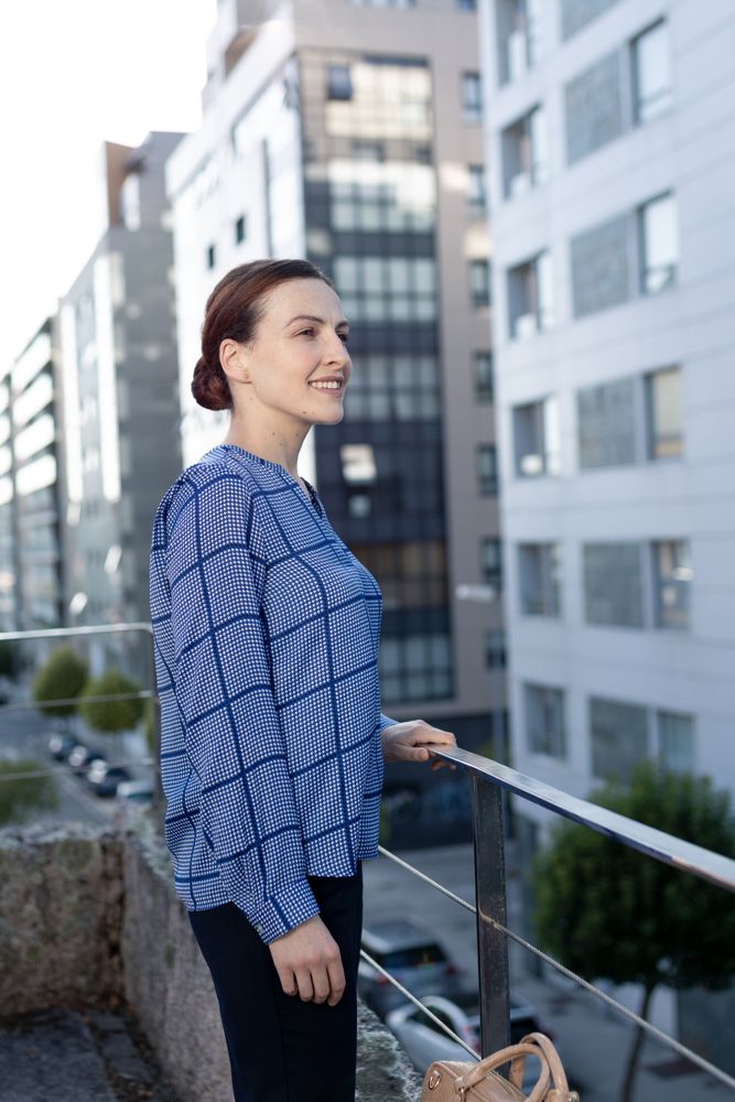Smiling businesswoman standing on balcony