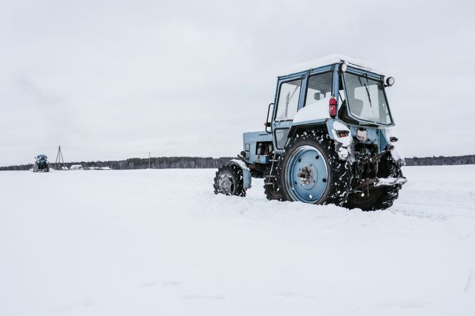 Tractors cleaning snow from field
