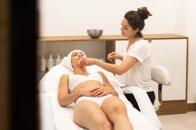 Female having a face mask cleaned off professionally