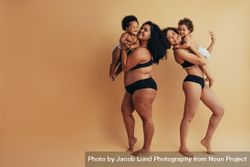New postpartum mothers confidently wearing dark undergarments and holding their infants 4APjE5