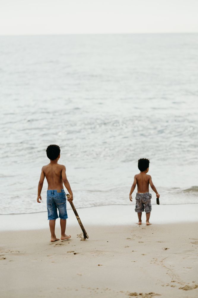 Black boys playing on beach