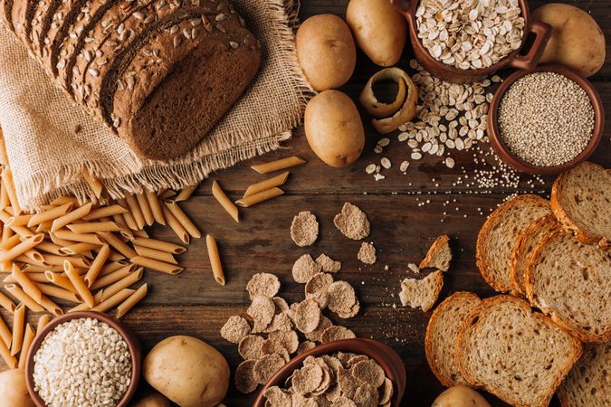 Wholegrain food and freshly baked rye bread on table