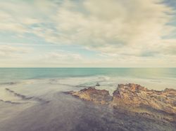 Rocky seashore under blue sky