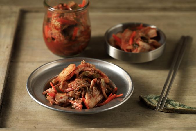 Napa cabbage kimchi on small korean side dish plate
