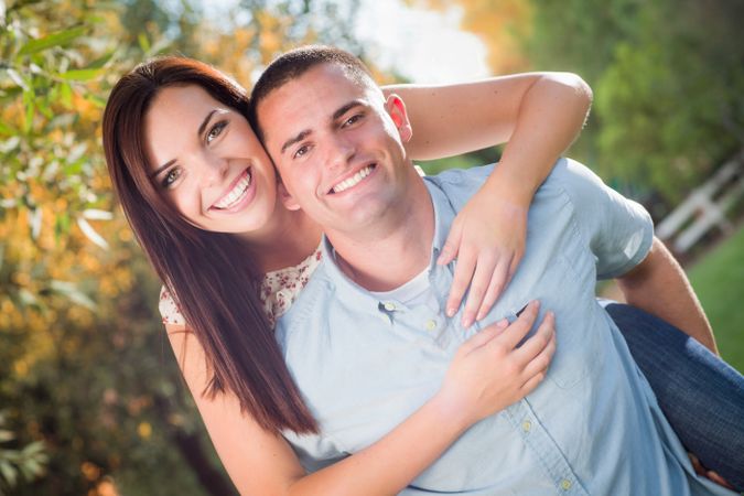 Happy Romantic Couple Piggybacking in the Park.