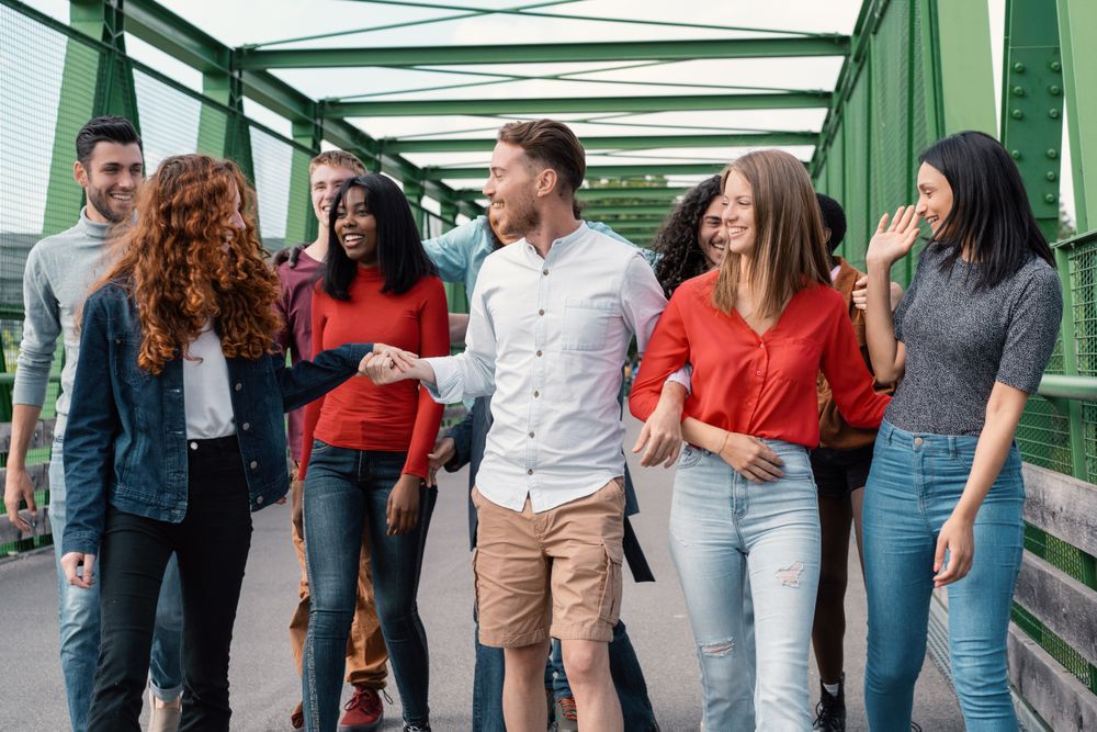 Multicultural friends enjoying city bridge walk