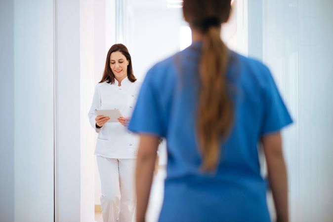 Doctor in white uniform walking along corridor