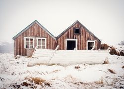 Deserted house between snowy field