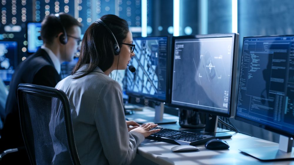 Female working in a Surveillance Team Gives Instructions with the Help of the Headsets.