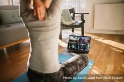 Fitness coach teaching yoga online to group of people 0y9XR0