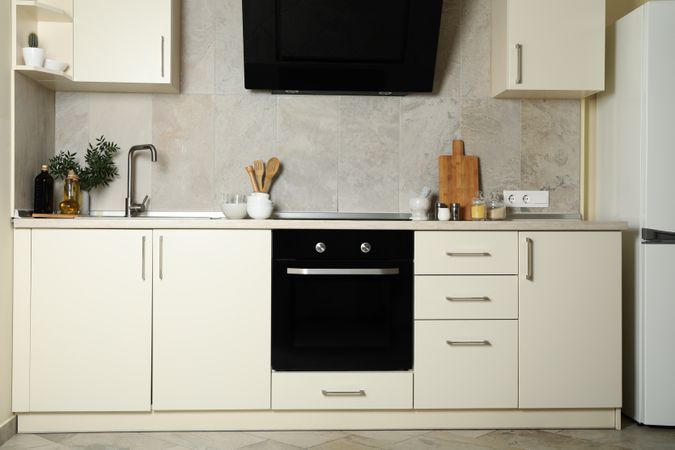 Modern kitchen interior with different supplies in light colors