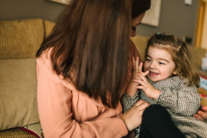 Woman hugging smiling daughter
