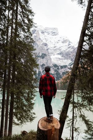 Man delighting in views near lake and mountains