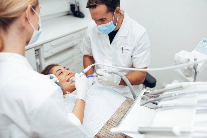 Woman getting a dental treatment in bright office