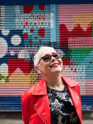 Smiling older woman in red leather jacket