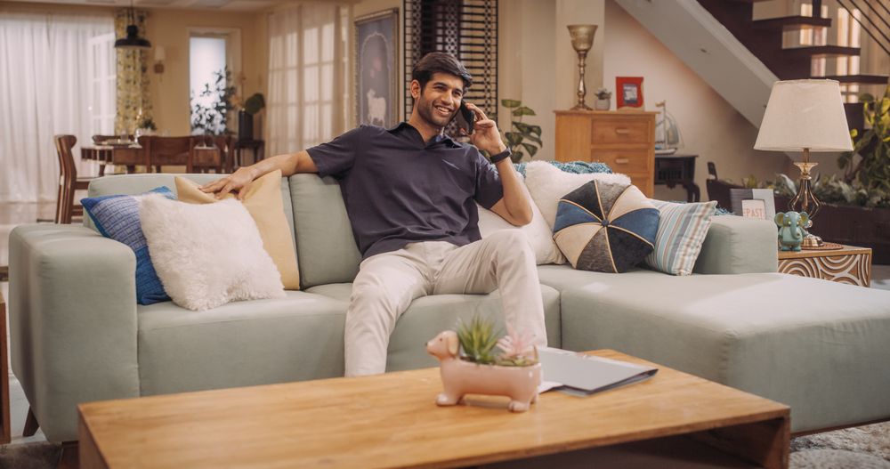 Young Indian Man Talking On His Smartphone, As He Shares His Entrepreneurial Skills with World Of E-Commerce.
