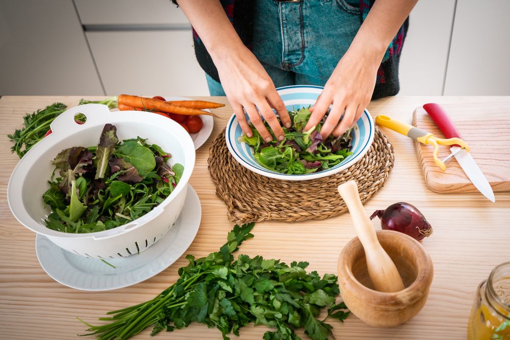 Woman preparing vegetable salad