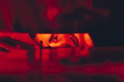 Man with drumsticks in redness