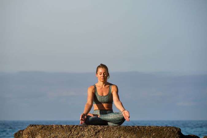 Woman meditating in Lotus pose