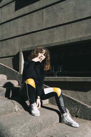Young woman smoking cigarette in the street