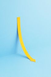 Yellow arrow pointing down while leaning on the wall