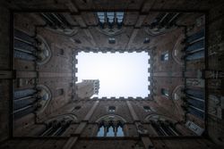 Perspective view from courtyard on stone tower