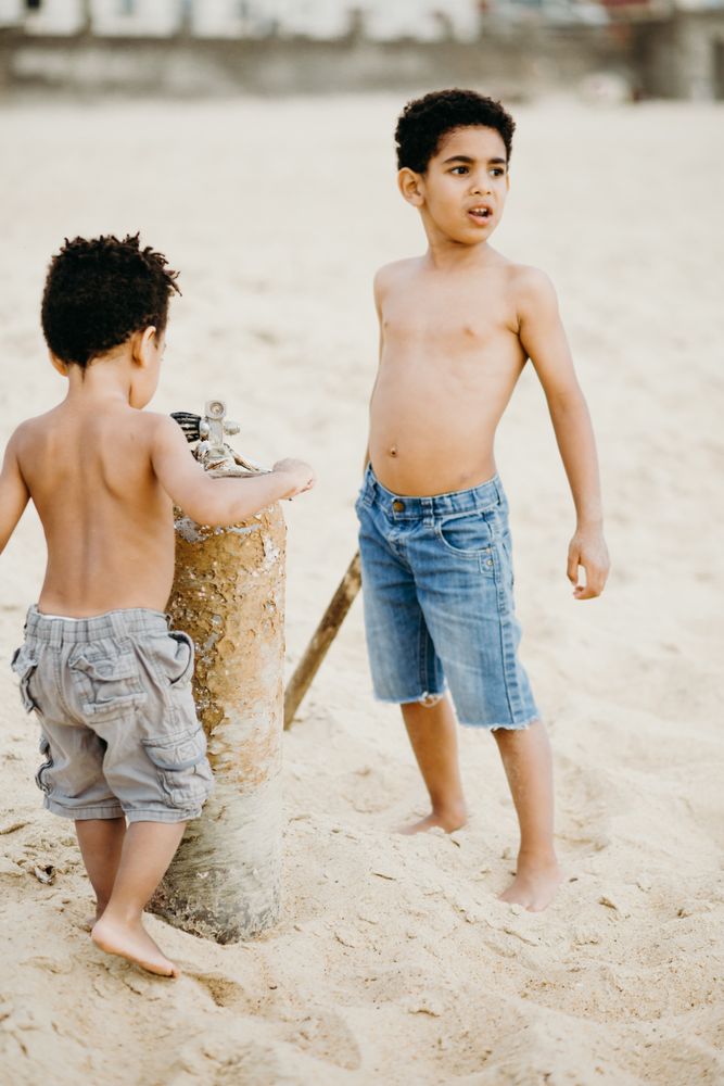 Black boys playing on beach