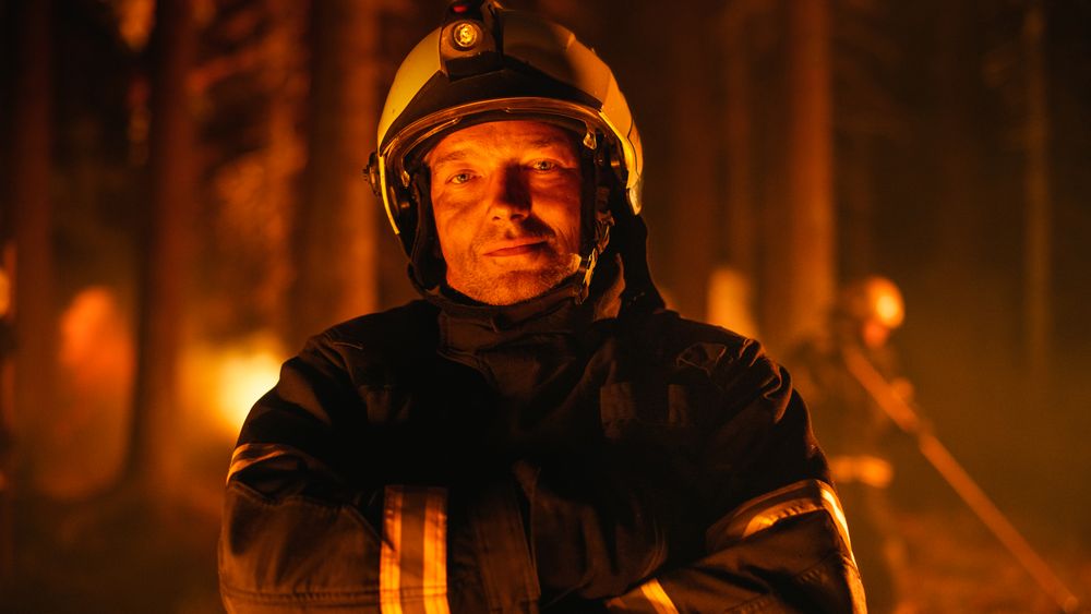 Professional Fireman Looking at Camera and Crossing His Arms Over Chest.