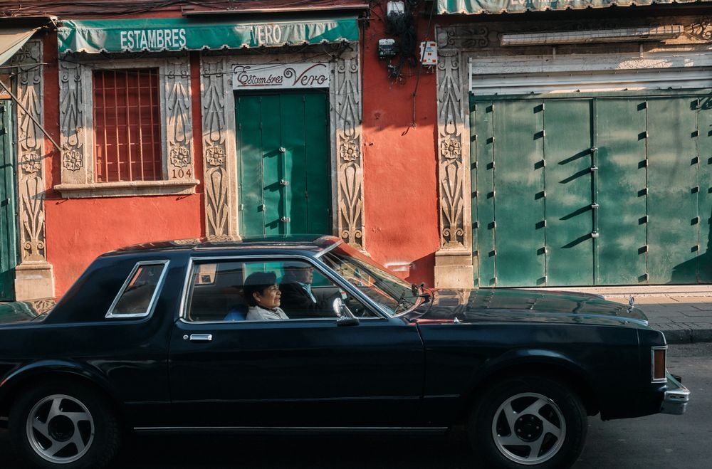 Man and woman driving in car on quiet street