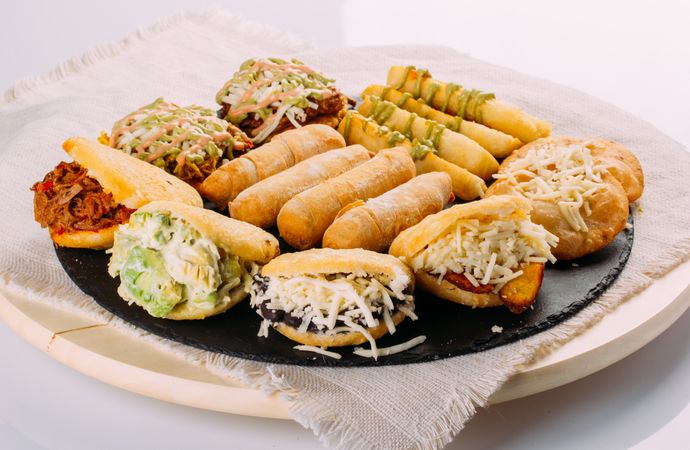 Venezuelan food tasting dish, the dish has arepas, tequeños, yuca and patacones