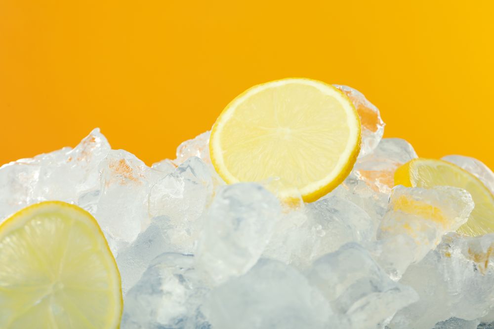 Pile of ice on orange background with slices