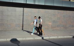 Couple walking and playing with their dog