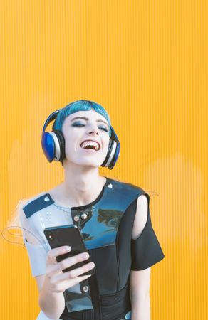 Futuristic woman using smartphone and listening to music