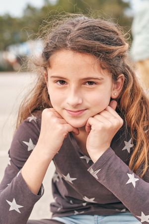 Tender teen girl looking at camera on street