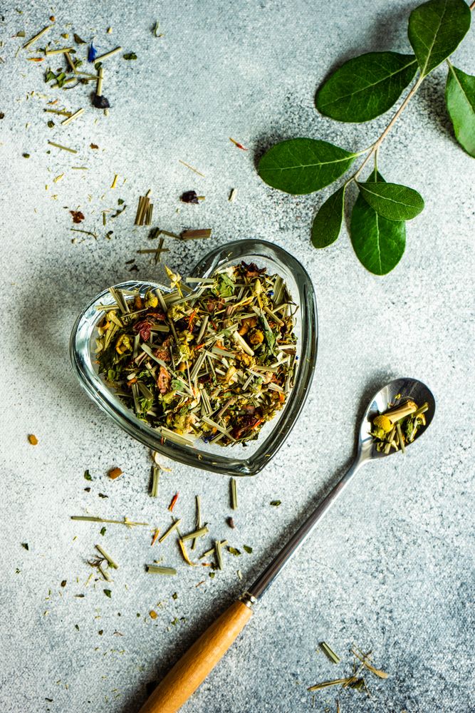 Loose leaf chamomile tea in heart container with spoon