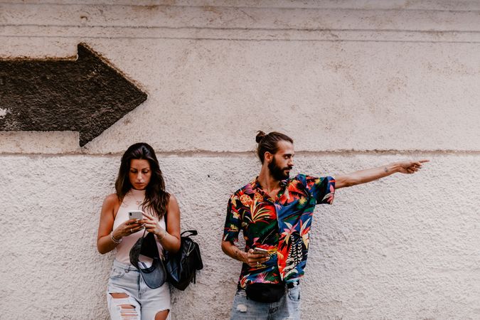 Couple searching for direction while strolling on street