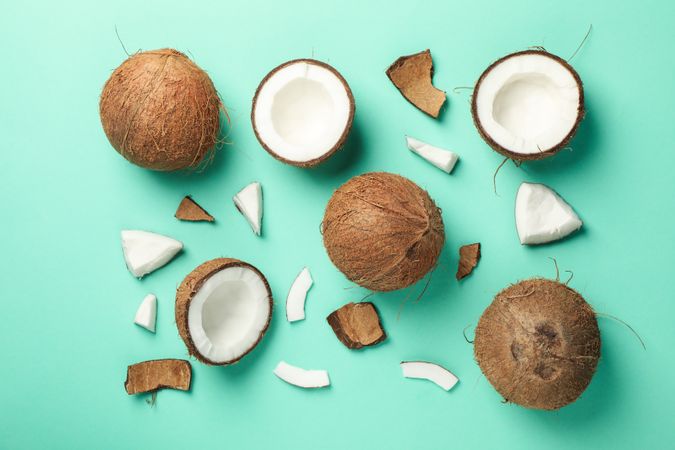 Flat lay with coconut on mint background, top view