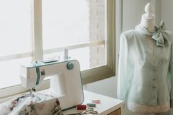 Dummy with blouse near sewing machine