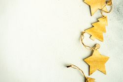 Tree and star Christmas ornaments on marble counter