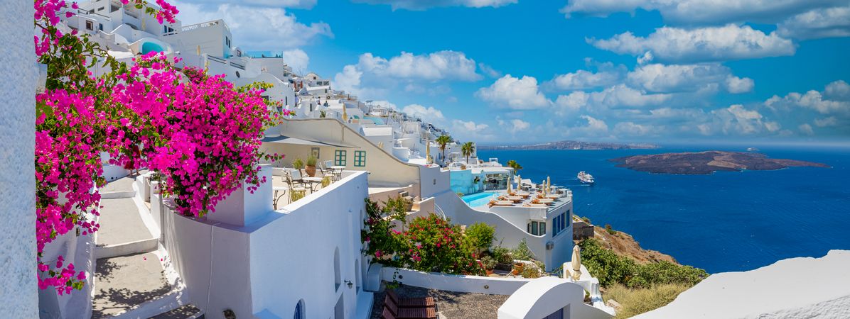Wide view shot with view of Aegean Sea and rooftops in Santorini