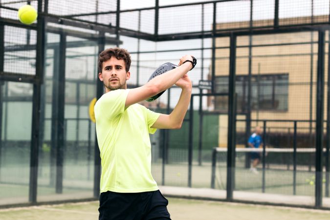 Man playing paddle tennis. backhand