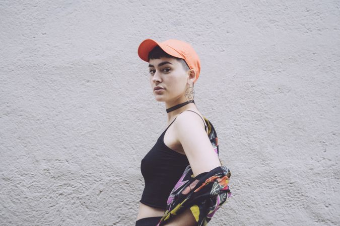 Woman in orange cap looking at camera sideways