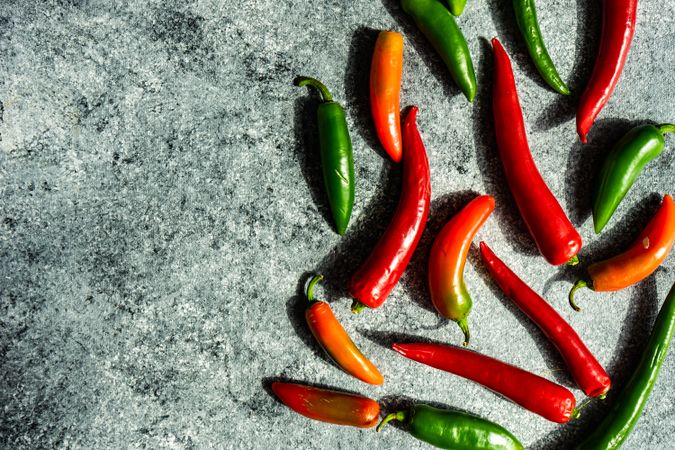 Spicy peppers on grey kitchen counter with copy space