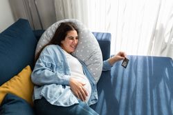 Happy pregnant woman looking at ultrasound photo