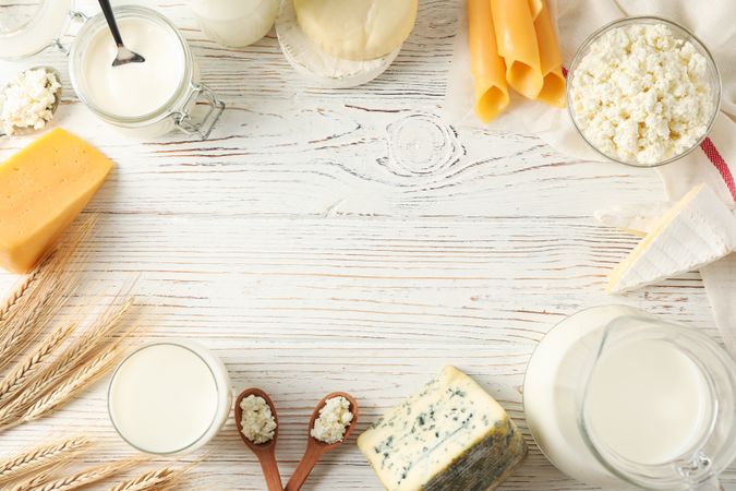 Flat lay. Different dairy products on wooden background, copy space